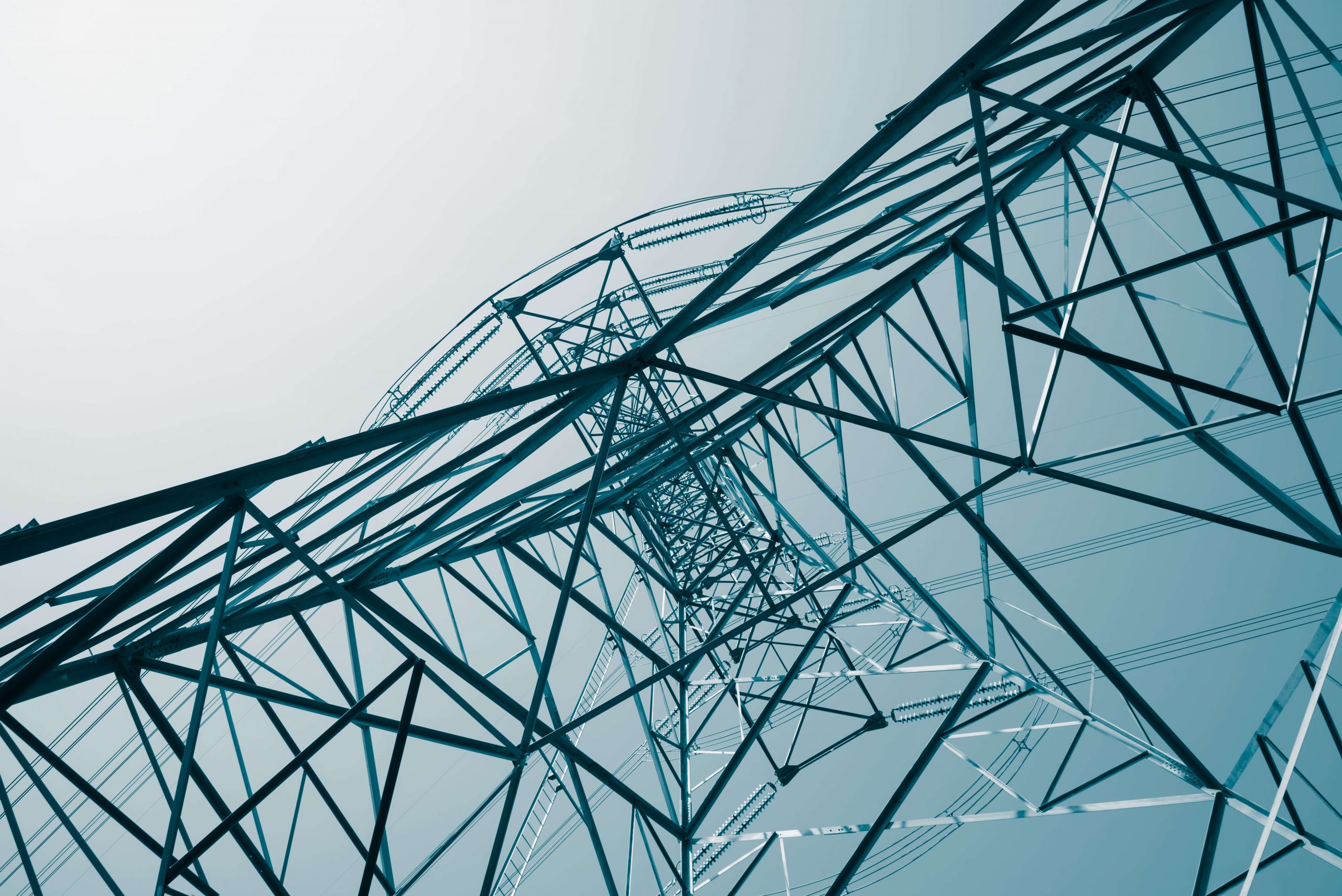 Transmission tower lattice against a pale sky